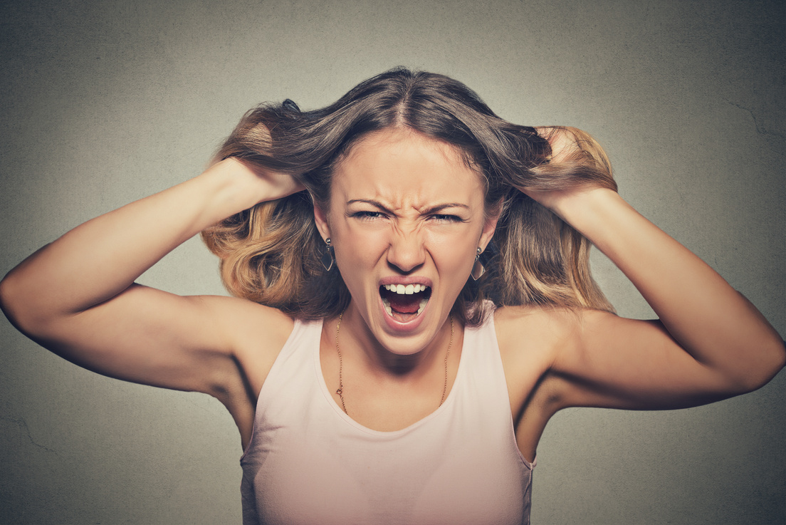 frustrated angry woman pulling hair out screaming